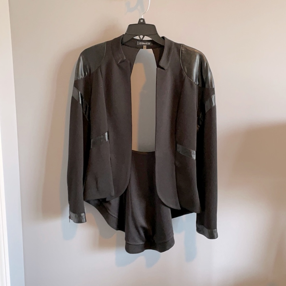 Small black open-backed jacket.
